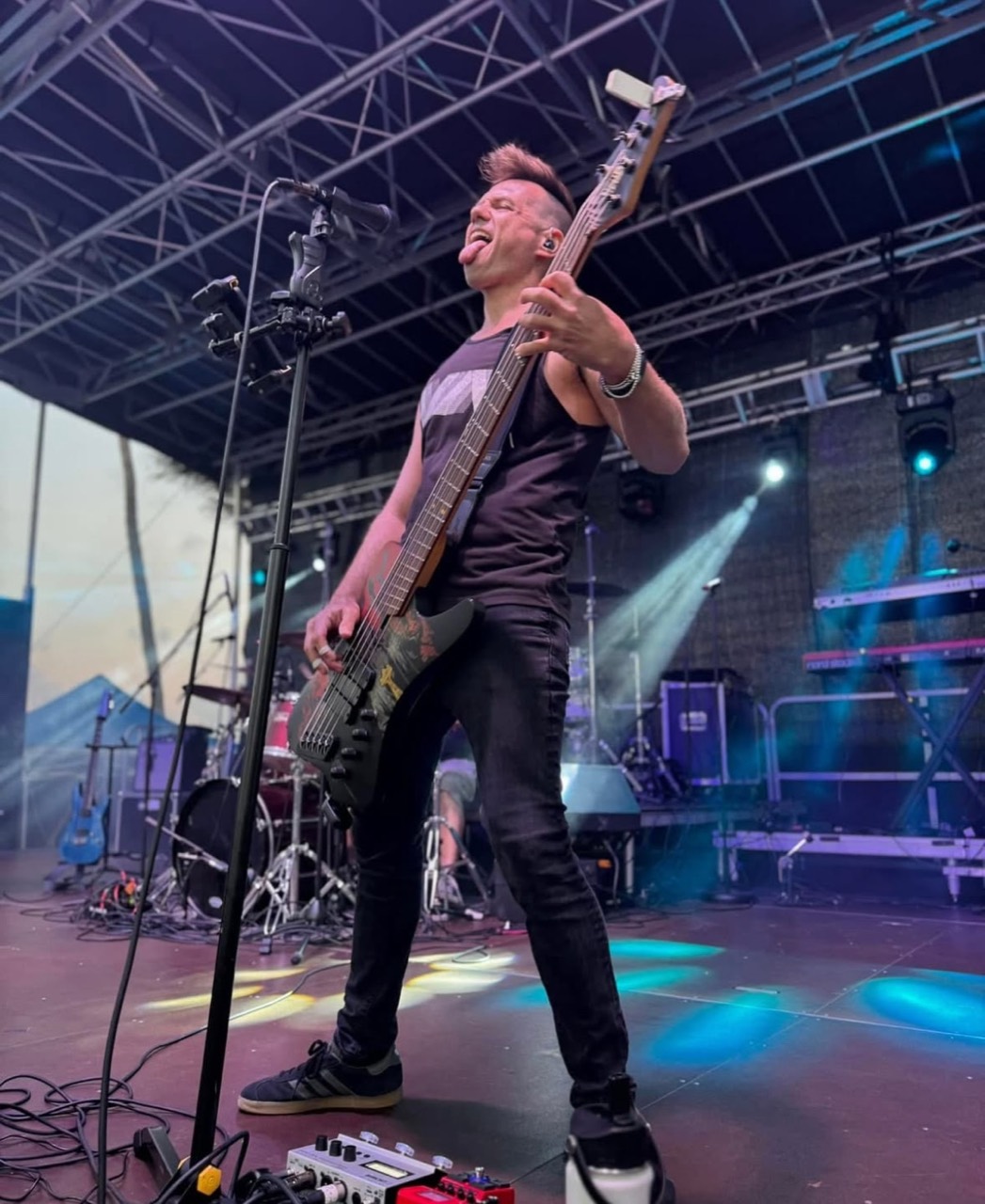 Force Majeure Rock bassist performing on stage